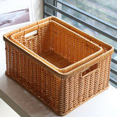 Medium-depth rectangular plastic rattan storage basket with sturdy handles, perfect for organizing household essentials.